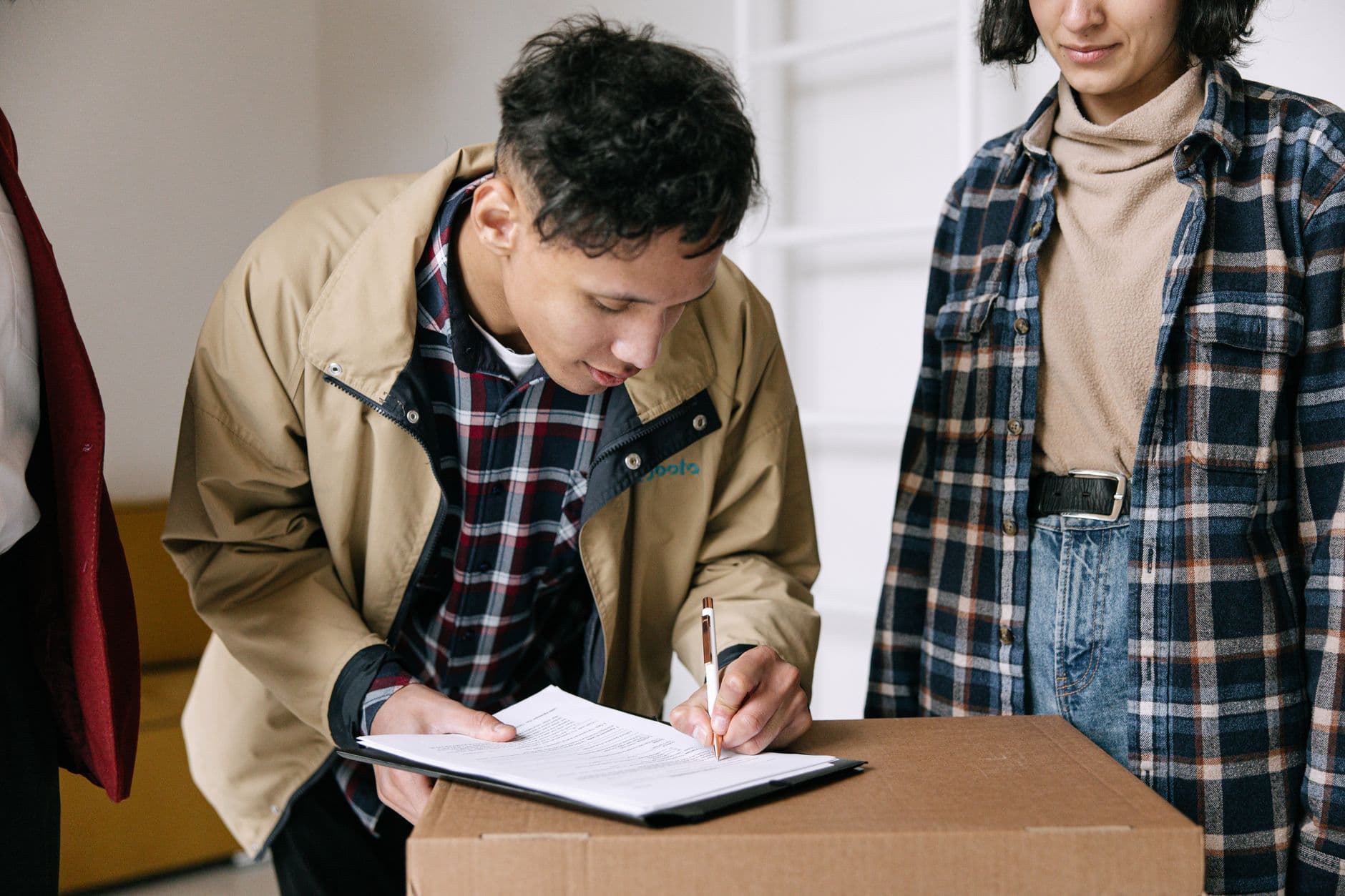Cartons de déménagement empilés avec un contrat à signer sur une table